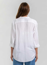 Schwangere Frau trägt weisse Umstandsbluse.  Diese elegante Schwangerschaftsbluse eignet sich für die Arbeit und die Freizeit.
